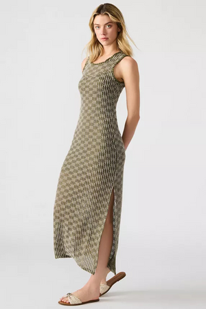 A woman wearing a knit dress with cream sandals. 