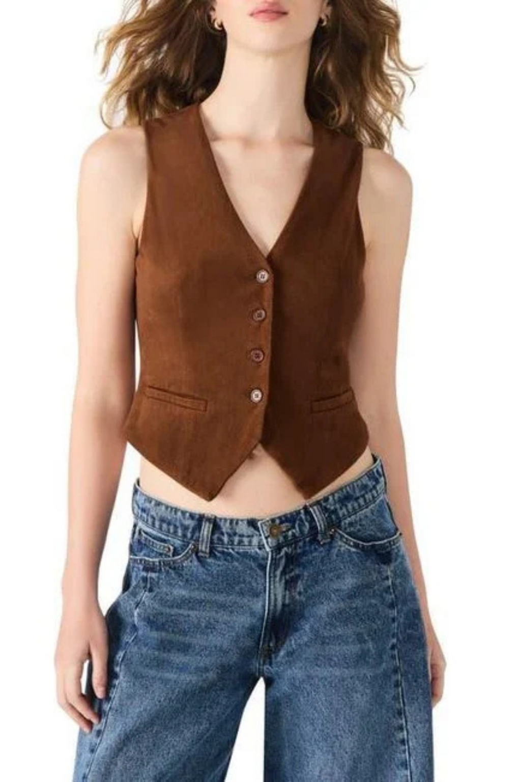 Woman wearing a brown suede vest over a blue denim top on a white background.