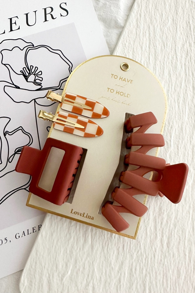 Set of hair clips on a branded card with a white background.