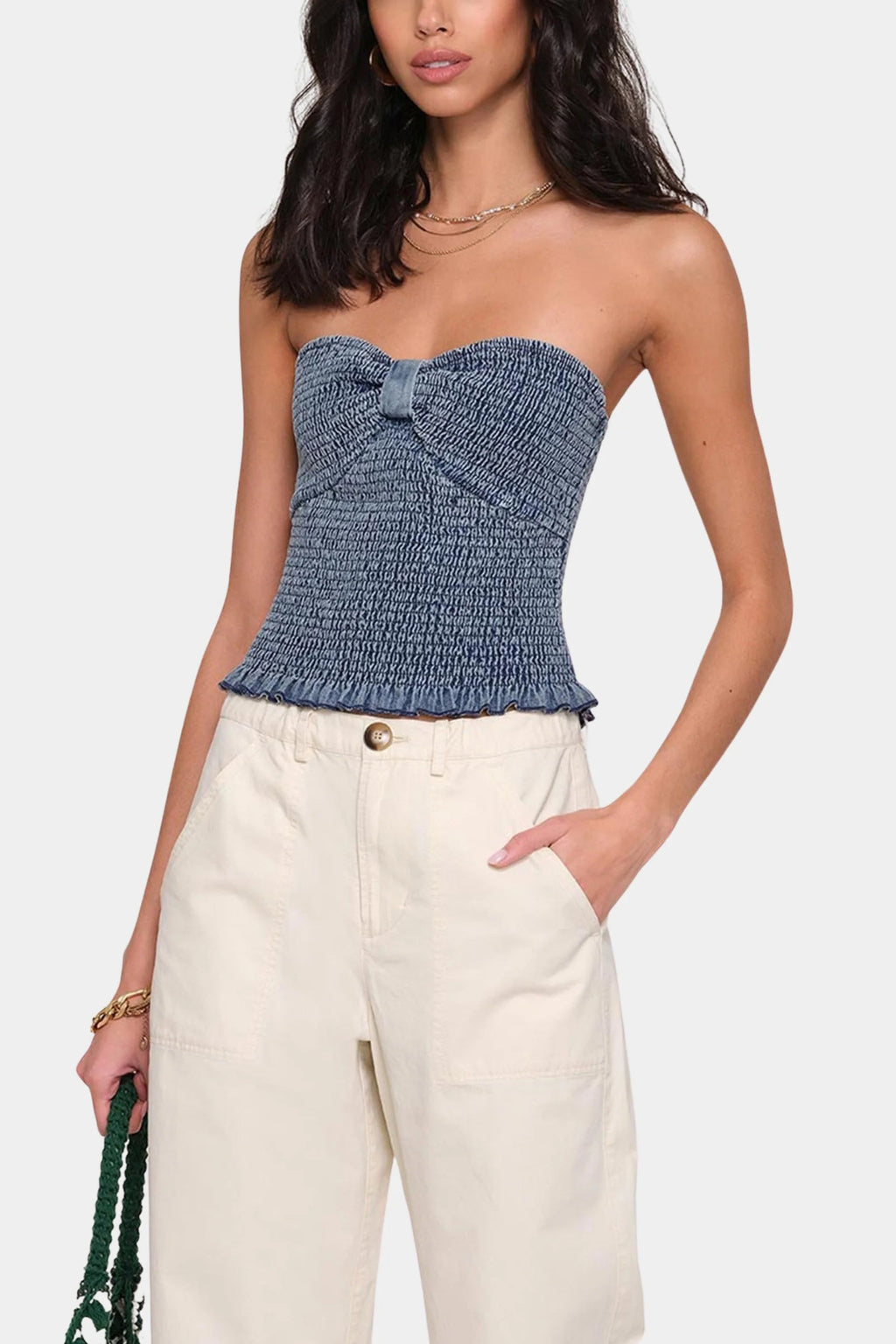 Heartloom Miska Top paired with a cream pair of pants and a purse.