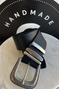 A close up shot of a black and silver buckle belt.