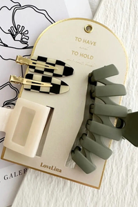 Set of hair accessories including clips and a bun maker on a branded card.