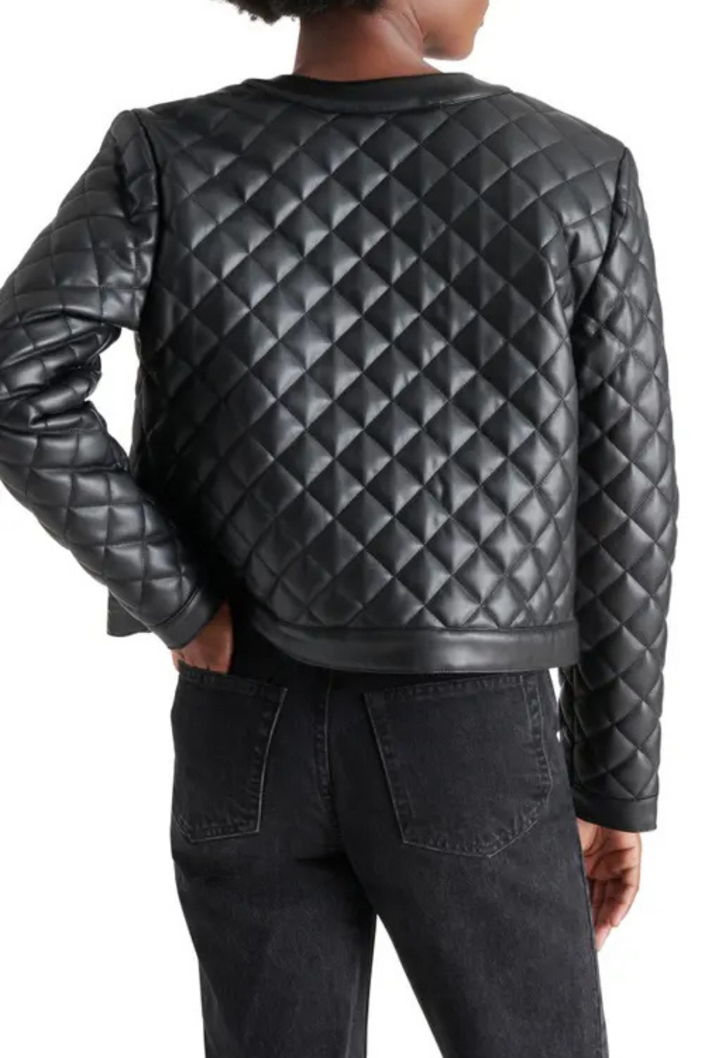 Black quilted jacket worn by a person on a white background.