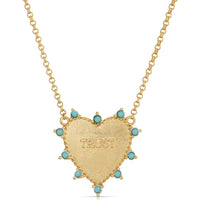 GOLD HEART NECKLACE WITH TURQUOISE AROUND IT. TRUST IS IN THE MIDDLE.