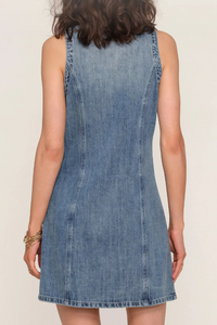 Denim dress back view worn by a woman on a plain background.