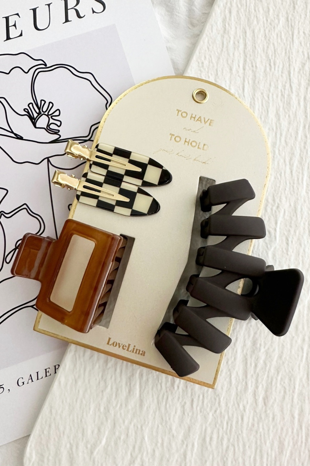 Set of hair clips on a branded card with a white background.