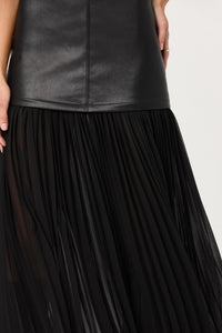 Black pleated skirt with a leather top on a white background.
