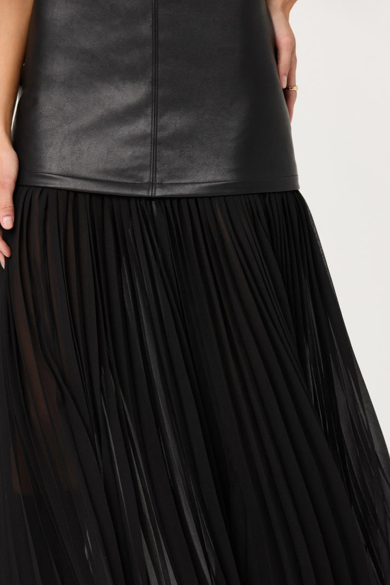 Black pleated skirt with a leather top on a white background.