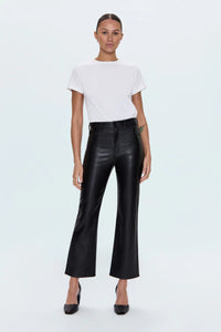 Person wearing a white t-shirt and black leather pants on a light blue background.