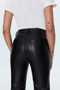 Person wearing black leather pants on a light blue background.