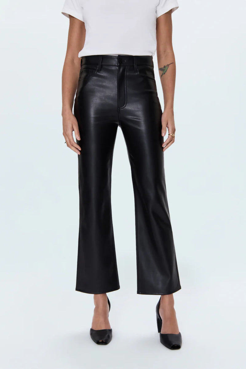 Person wearing black leather pants on a white background.
