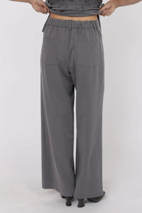 Gray wide-leg pants worn by a person on a white background.