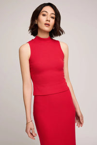 Woman wearing a red sleeveless top and skirt against a plain background.