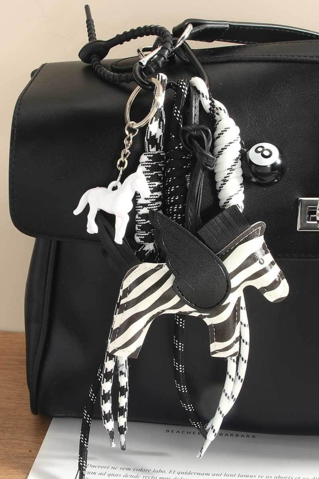 Bag charm of a zebra pegasus.