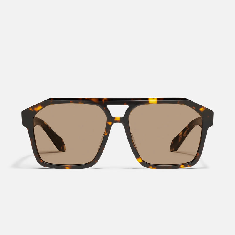 Sunglasses with tortoiseshell frame and brown lenses on a white background