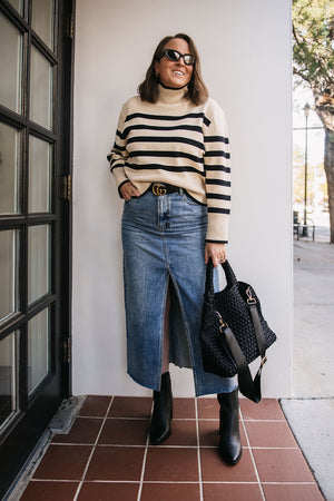 Woman wearing striped sweater and denim midi skirt in downtown billings, montana
