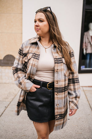 woman wearing plaid shacket and levis icon denim skirt in downtown billings