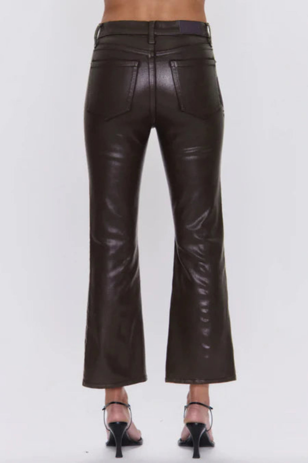 Dark brown leather pants on a white background.