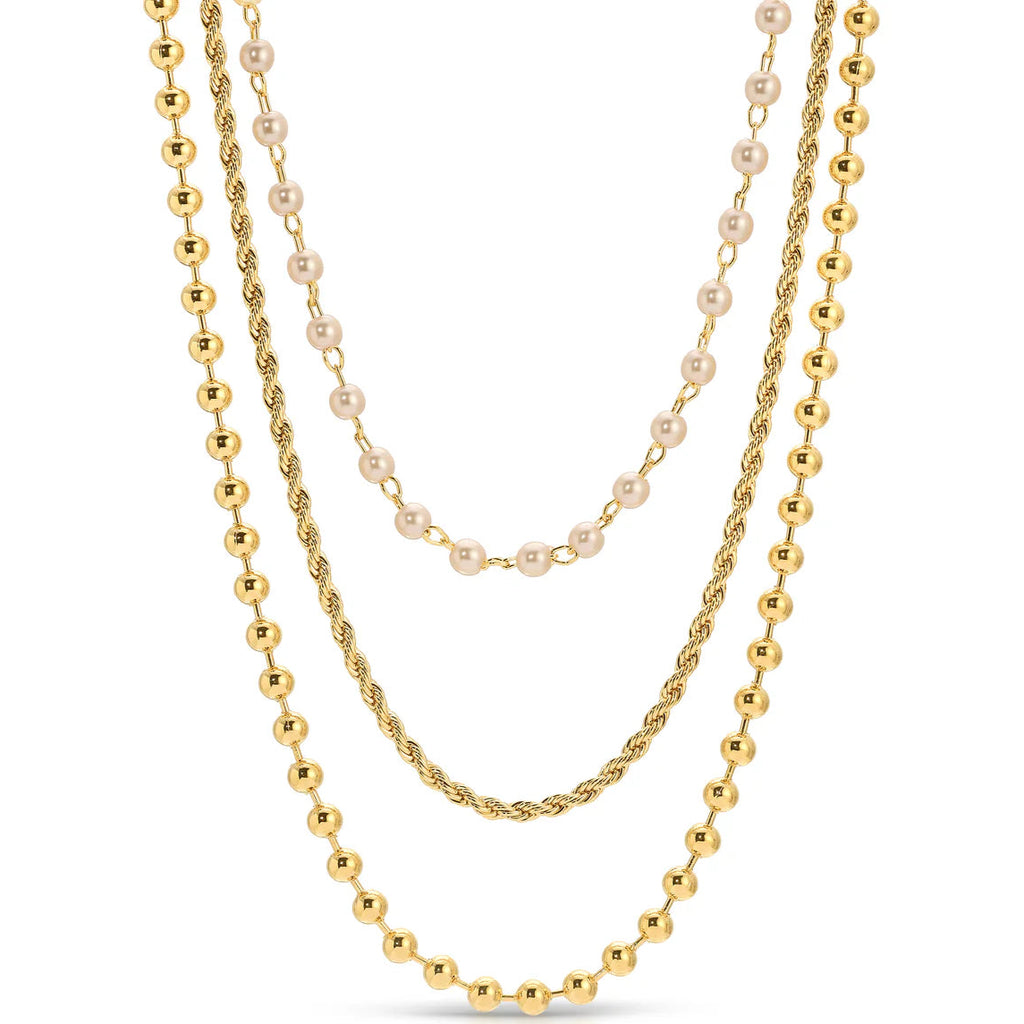 Three gold necklaces with different designs on a white background.