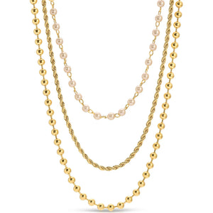 Three gold necklaces with different designs on a white background.