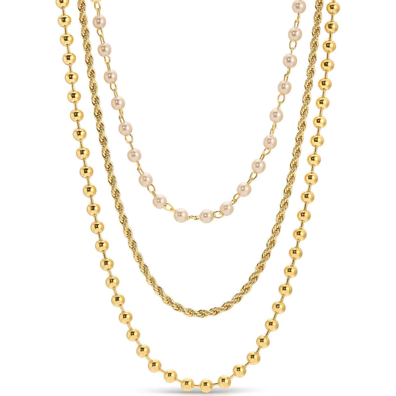 Three gold necklaces with different designs on a white background.