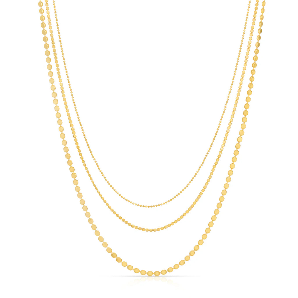 Three gold necklaces of different lengths on a white background
