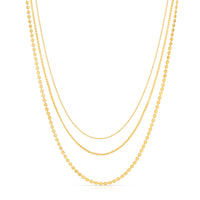 Three gold necklaces of different lengths on a white background