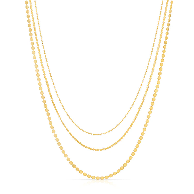 Three gold necklaces of different lengths on a white background