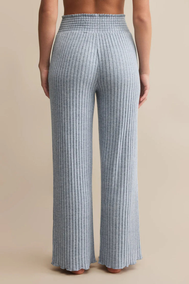 Blue checkered pants worn by a person on a beige background.