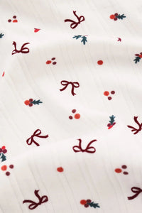 White fabric with red bows and berries pattern.