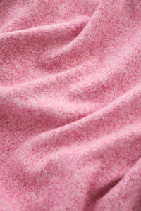Close-up of pink fabric with a soft texture.