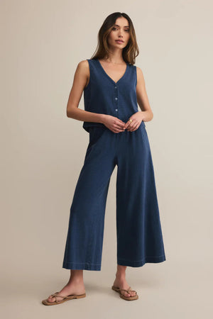 Woman wearing a blue matching set on a beige background.