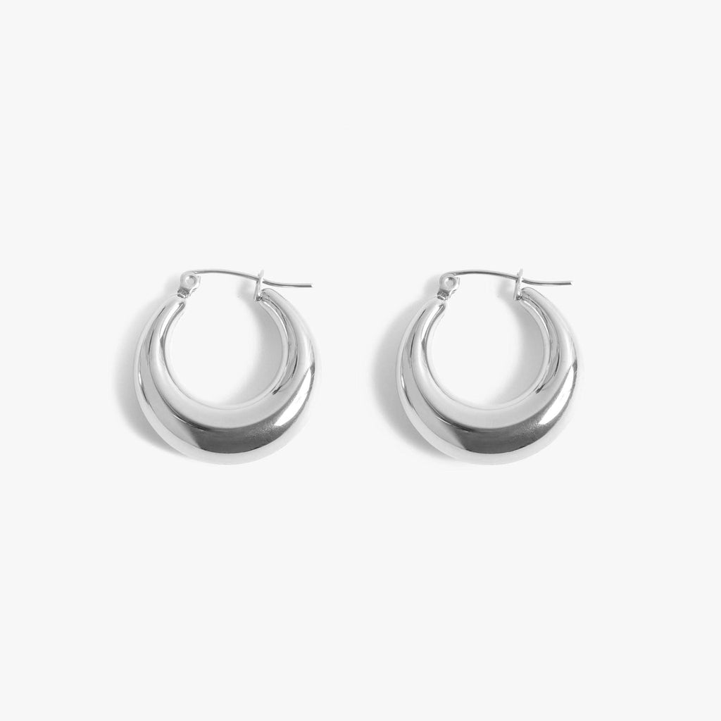 A pair of silver hoops earrings.